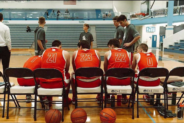 The boys basketball team planning out there next play
