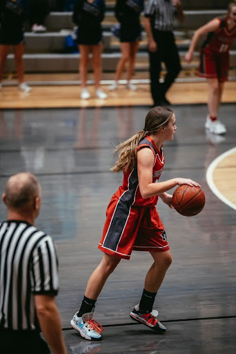 Mackenzie dribbling the ball down the court in one of their games.