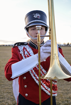 Green posing with his trombone while in uniform. 